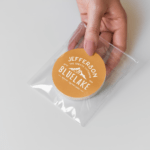 Een kleurrijke sticker op een plastic zakje, met stickers op rol